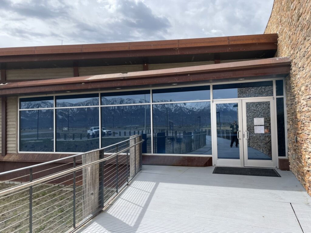 Large windows and doors reflect the landscape, which causes confusion for birds that mistake the glass as open air. Courtesy US FWS, Bear River Migratory Bird Refuge, Karleen Vollherbst